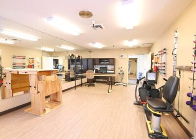 therapy room with full size mirror and exercise equipment