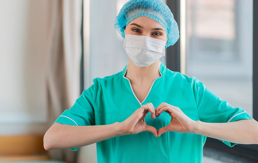 nursing aide making a heart hand gesture